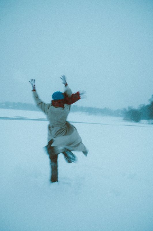 Person running away from the camera on a snowy lake