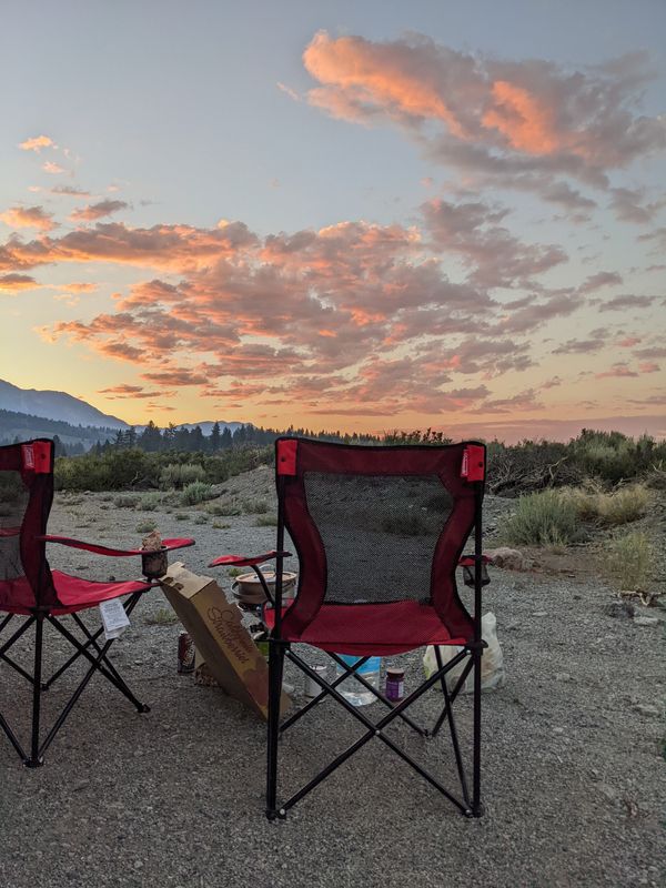 Two camp chairs in front of a glorious pink sunset