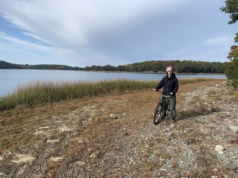 Rey with a bicycle on a path around a lake